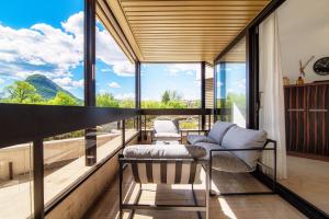 a living room with a view of the mountains at The Central Home by Quokka 360 - Next to Lido di Lugano in Lugano