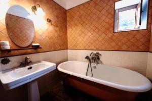 y baño con bañera, lavabo y espejo. en Finca La Sabina, en Guarazoca