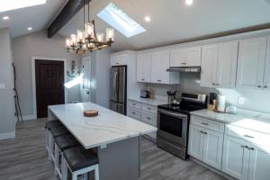 a kitchen with white cabinets and a white counter top at Sun Drenched Lakefront Cove in Monticello