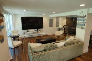 a living room with a couch and a flat screen tv at Sun Drenched Lakefront Cove in Monticello
