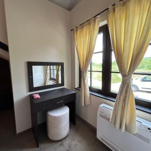 a room with a television and a window with curtains at Геша Форест in Dryanovo +54 photos