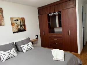 a bedroom with a bed and a wooden cabinet at Casa Entre Glaciares in Puerto Natales