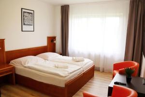 Postel nebo postele na pokoji v ubytování B&B Hotel Volčík