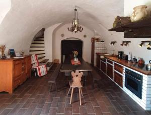 a kitchen with a table and a chair in a room at Traditional cottage at Lake Balaton in Vászoly