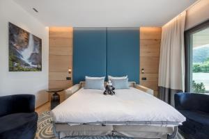 a bedroom with a bed and two chairs at Rivage Hôtel & Spa Annecy in Annecy