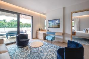 a living room with two chairs and a table at Rivage Hôtel & Spa Annecy in Annecy