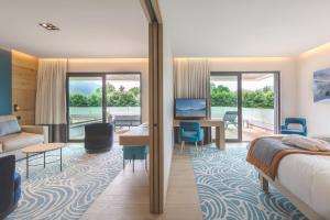 a hotel room with a bed and a desk at Rivage Hôtel & Spa Annecy in Annecy