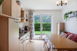 a kitchen with a table and a large window at Apartment Tux in Mayrhofen