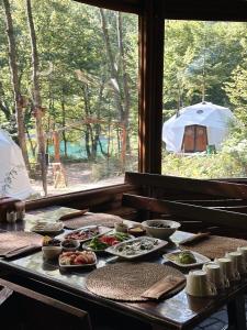 a table with plates of food and a tent at Ala Glamping in Mudurnu