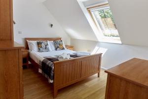a bedroom with a bed and a window at Selwood Cottage in Beckington