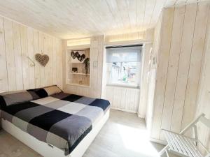 a bedroom with a bed in a room with wooden walls at You and Me nel cuore antico di Aosta in Aosta