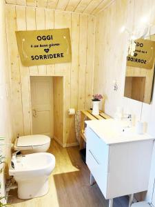 a bathroom with a toilet and a sink at You and Me nel cuore antico di Aosta in Aosta