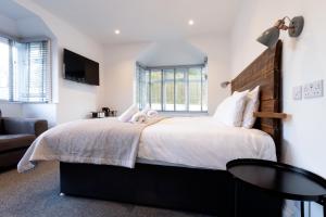 a bedroom with a large bed and a couch at The Nook - Self Serviced Accommodation in St Ives