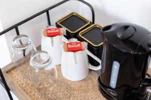 a group of coffee cups and glasses on a counter at The Nook - Self Serviced Accommodation in St Ives