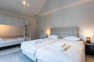 a bedroom with two beds with towels on them at Résidence Méri-Bellecombe in Brides-les-Bains