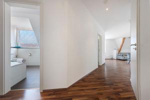 an open hallway with white walls and wood floors at Haus Hannover in Hannover