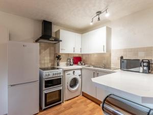 a kitchen with a dishwasher and a washer at 2 Bed in Hayfield PK551 in Hayfield