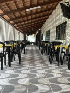 a row of tables and chairs on a patio at Hotel Nossa Senhora de Lourdes in Trindade