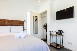 a bedroom with a bed and a flat screen tv at The Nook - Self Serviced Accommodation in St Ives