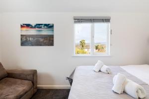 a bedroom with a bed and a couch at The Nook - Self Serviced Accommodation in St Ives