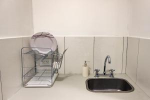 a kitchen sink with a basket next to it at Suite in Tres Arroyos