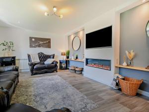 a living room with a couch and a fireplace at 3 Bed in Crackington Haven 09117 in Saint Gennys