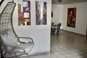a room with two chairs and paintings on a wall at Group Unit Great Location in San Juan
