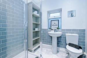 a bathroom with a toilet and a sink at Cosy Modern 3-BR Apartment - Sleeps 5 in Liverpool
