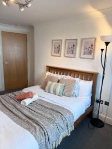 a bedroom with a large bed with two pillows at Luxury Rooms just off broad St Walking distance to city centre in Birmingham