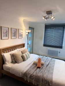 a bedroom with a large bed with a window at Luxury Rooms just off broad St Walking distance to city centre in Birmingham