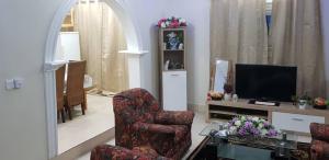 a living room with two chairs and a television at Terrouwaar apartment in Sanyang