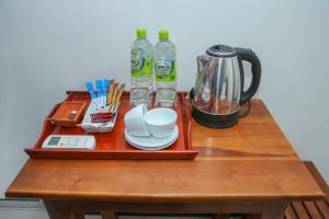 a tray with two bottles of water and a coffee maker on a table at Kandy Tower Inn in Kandy