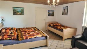 - une chambre avec deux lits et une chaise dans l'établissement Ferienwohnung Zauberhaft, à Bad Soden-Salmünster