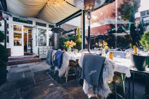 a restaurant with tables with blankets on them at Purchases Restaurant & Accommodation in Chichester