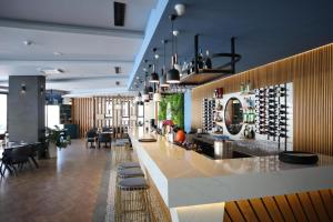 a bar in a restaurant with a bunch of wine bottles at Caesar Blue Resort Studio with Sea View in Trikomo