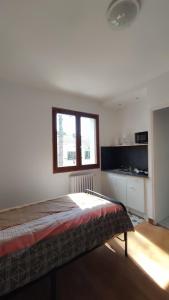 a bedroom with a bed and a window at LE VILLAGE DU PARC in Aigre