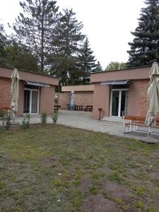 a building with umbrellas in front of it at Öreg-tó Youth Hostel in Tata