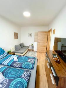 a bedroom with a large bed and a couch at Moderne Ferienwohnung Felbbauer #30 in Knittelfeld