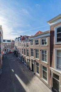 an empty street in a city with buildings at Apartment Viognier in The Hague