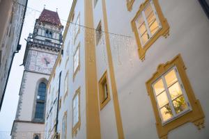 a building with a clock tower in the background at Hotel Wilder Mann in Passau