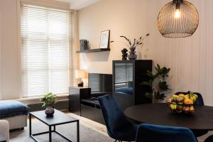 una sala de estar con una mesa con un bol de fruta. en Apartment Viognier, en La Haya
