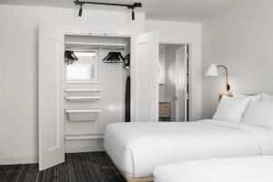 a bedroom with two beds and a closet at TownePlace Suites by Marriott Iron Mountain in Iron Mountain
