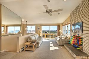 a living room with a couch and a ceiling fan at Narragansett Home with Scenic Deck Less Than 2 Mi to Beach! in Narragansett