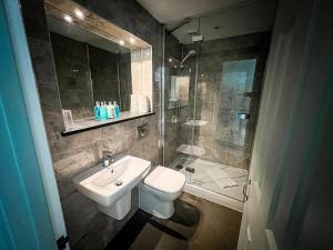 a bathroom with a sink and a toilet and a shower at Rock House Hotel in Lynmouth +31 photos
