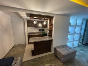 a kitchen with a counter and a sink in a room at Lindo apartamento in Tunja