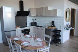 a kitchen with a table and chairs in a kitchen at Escapade Sélest' in Sélestat