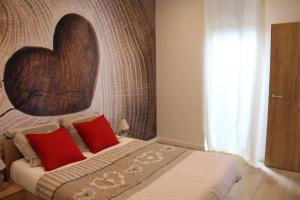 a bedroom with a bed with a large heart headboard at Escapade Sélest' in Sélestat
