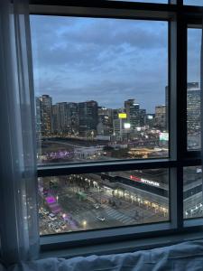 a view of a city skyline from a window at Seoul downtown 3min to Seoul station in Seoul