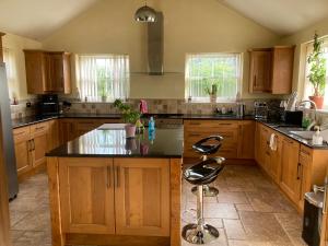 a kitchen with wooden cabinets and a black counter top at Private room Bishop Norton in Market Rasen