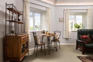 a dining room with a table and chairs at Old Round House with hot tub in Padstow